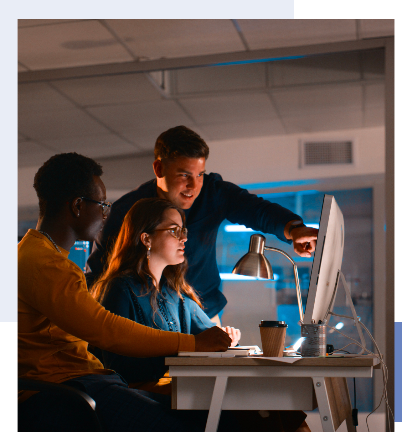 Office teamwork around a monitor