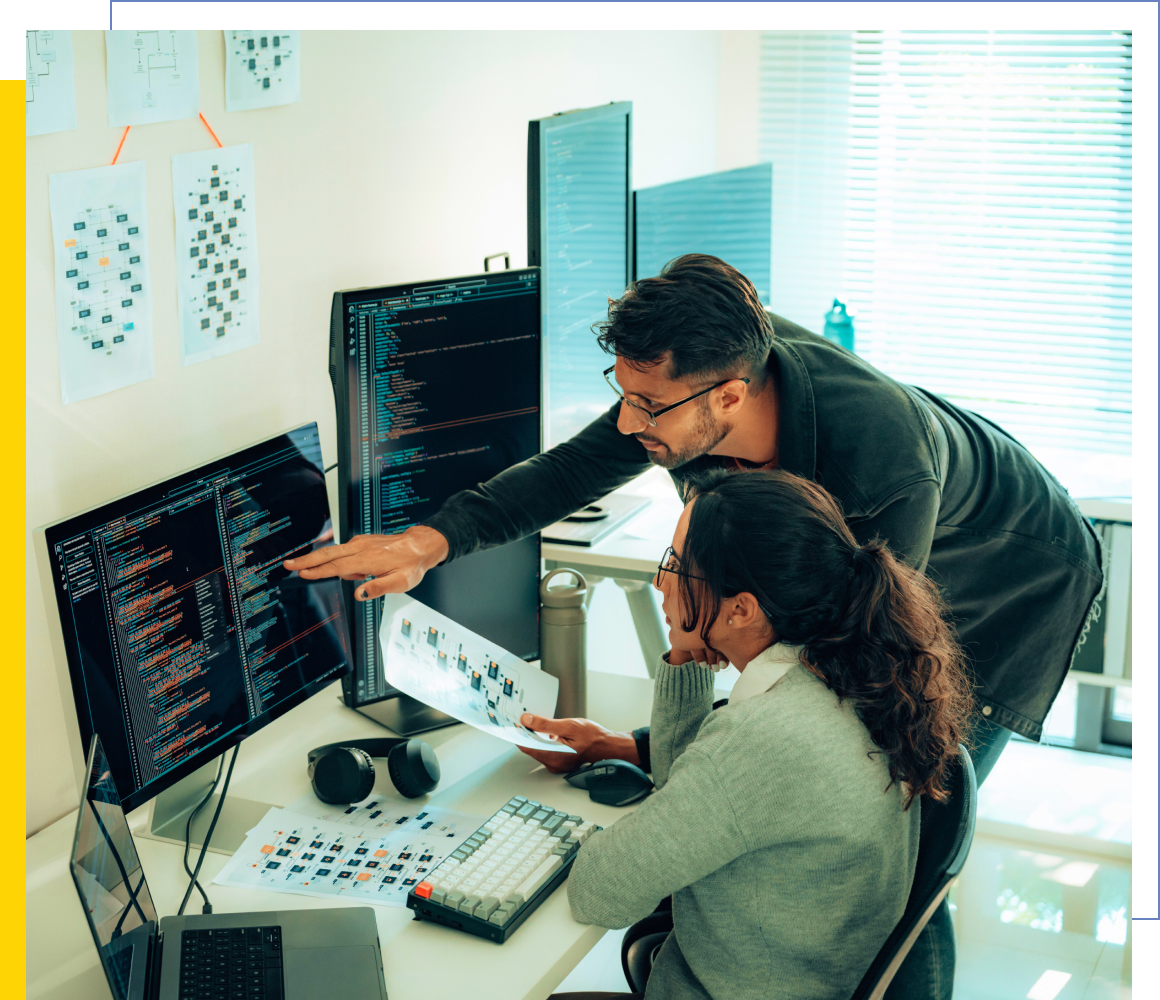 Two colleagues analyzing computer data