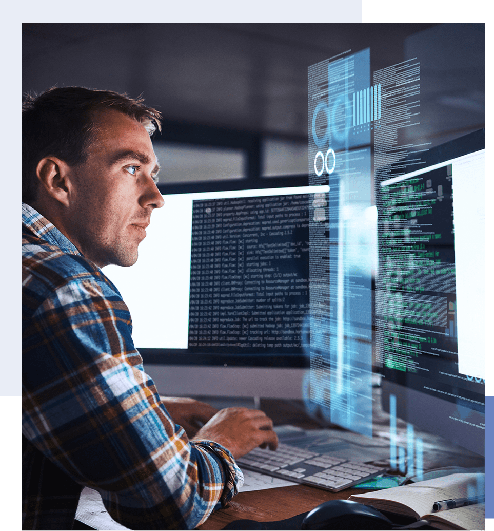 Man coding on dual monitors