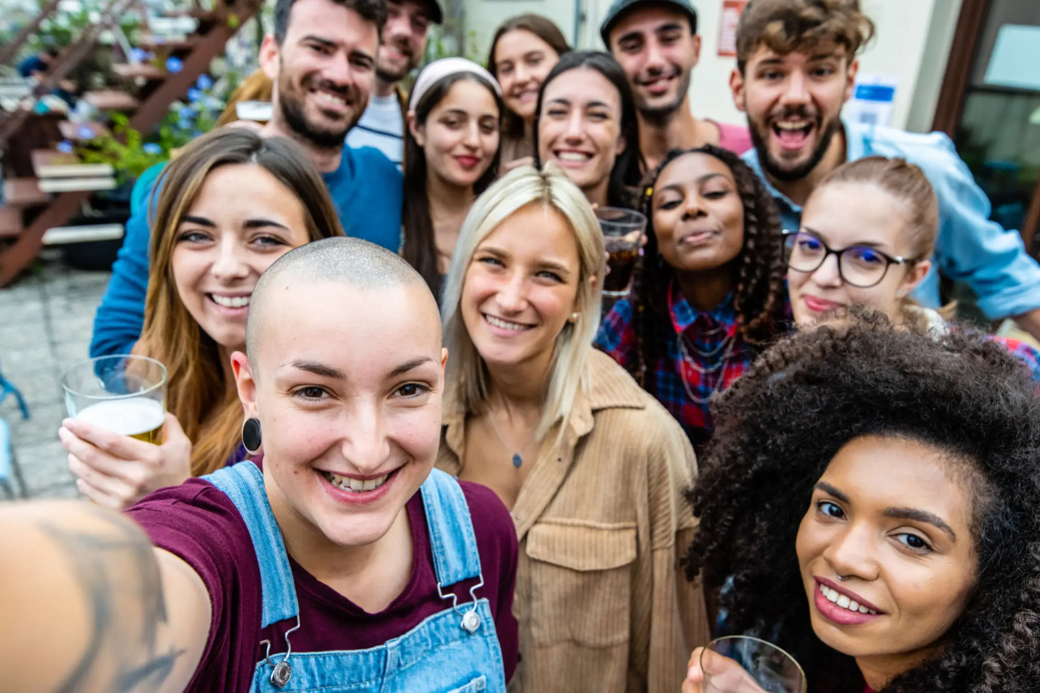 A diverse group of friends smiling together for a selfie.